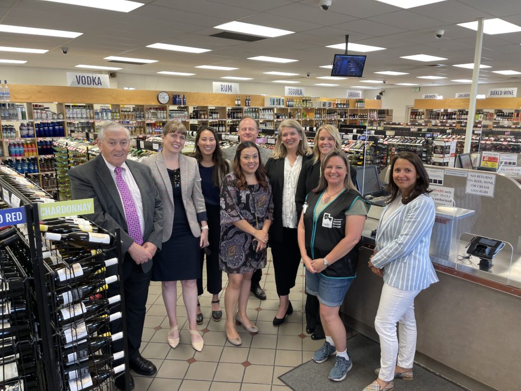 Members of the DABS commission and leadership pose for a picture in a Logan state store.